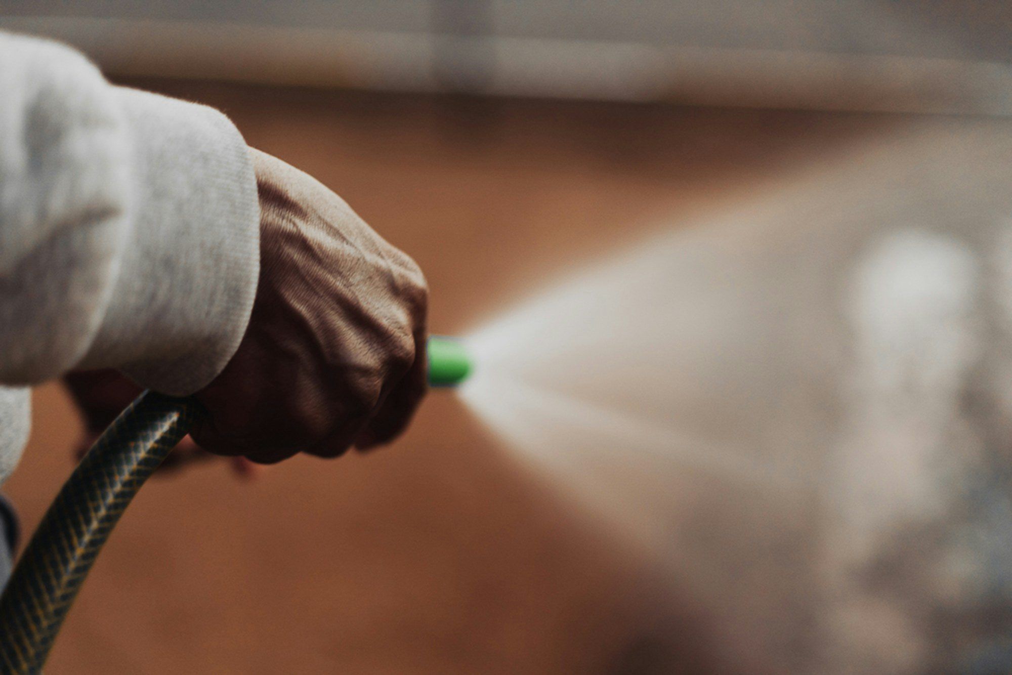 Close-up of a pressure washer nozzle spraying water